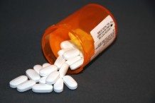 prescription drug bottle with pills spilling out