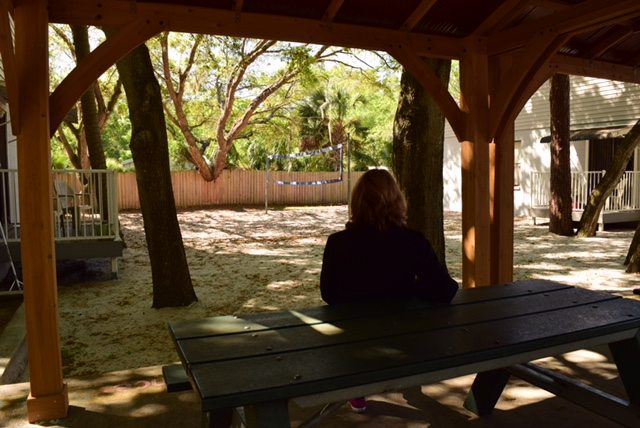 woman sitting on bench at turning point of tampa addiction treatment center campus
