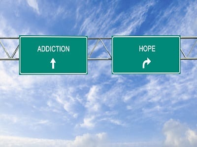 Road sign to addiction and hope