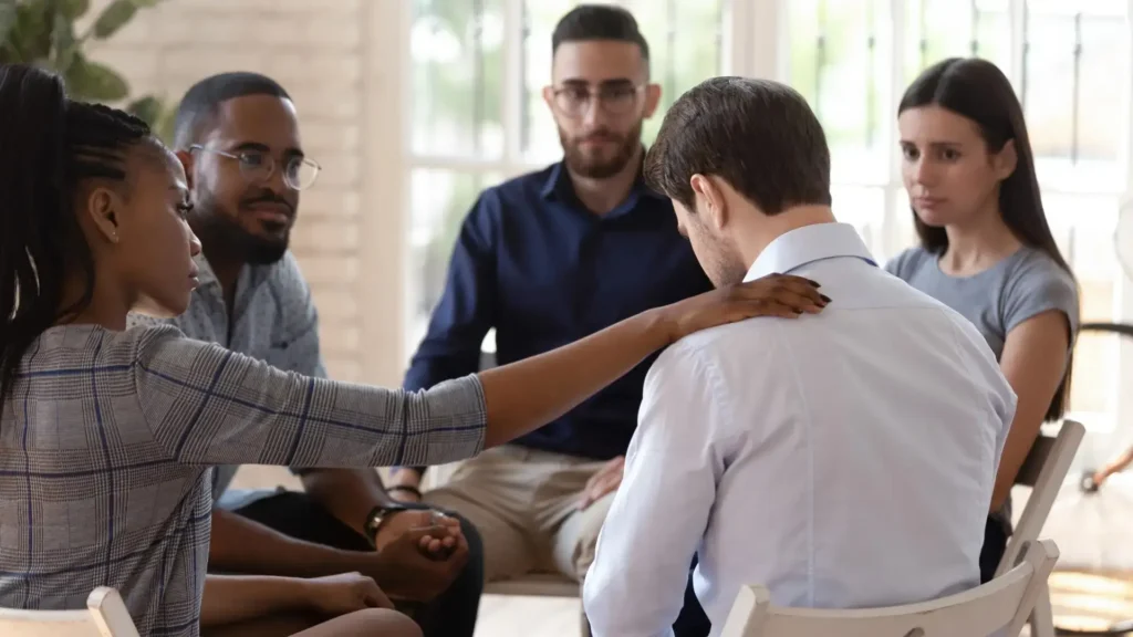 Person Sitting Outdoors on a Bench in a Quiet Garden Setting During Alcohol Addiction Recovery | Turning Point of Tampa